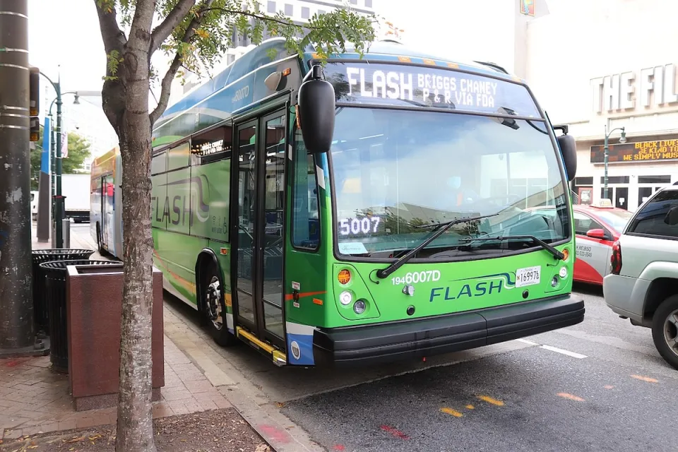 Green public transit bus at stop in Silver Spring, Maryland.